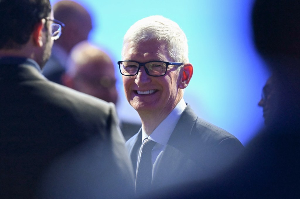 US businessman Tim Cook reacts during the World Economic Forum (WEF) annual meeting in Davos on January 21, 2026. The World Economic Forum takes place in Davos from January 19 to January 23, 2026. (Photo by Fabrice COFFRINI / AFP)